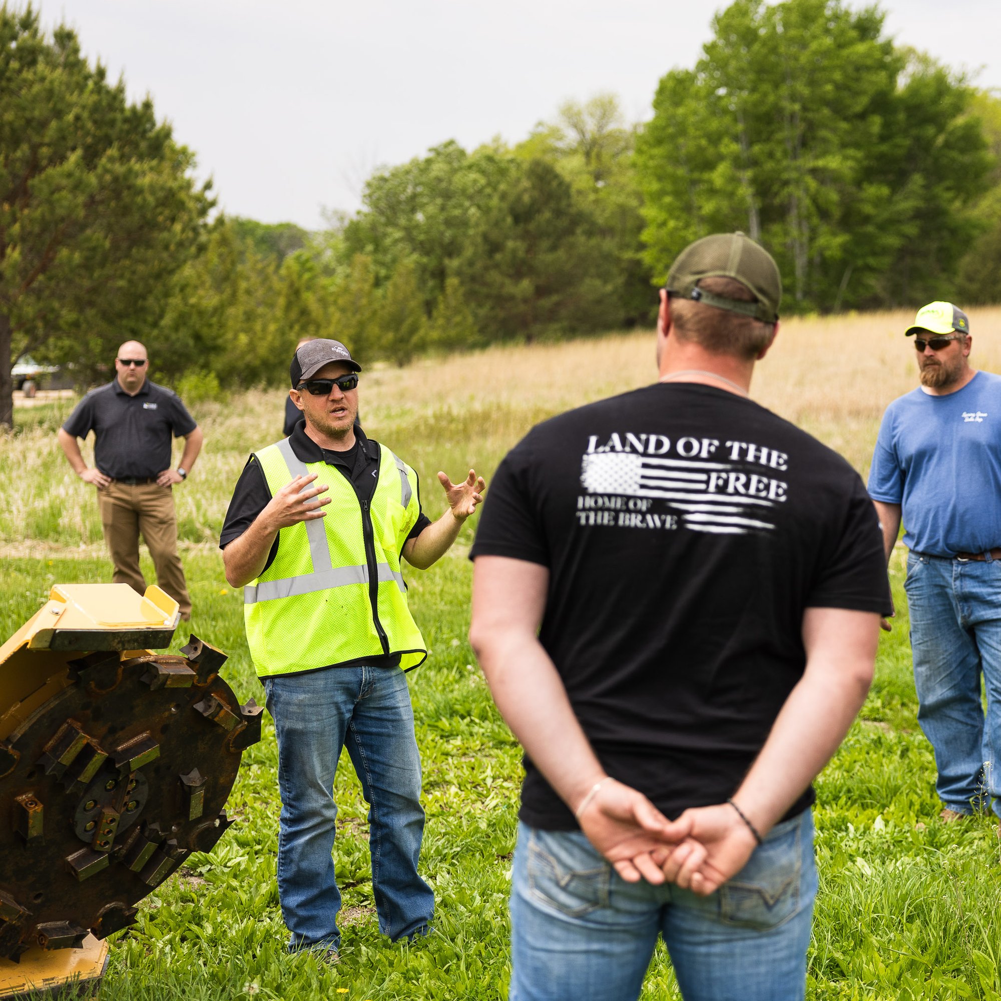 people around an attachment showing the operation